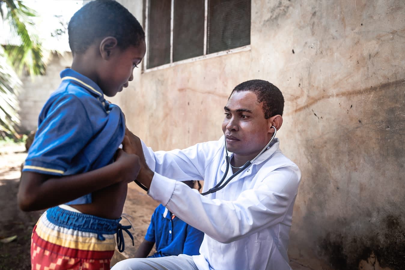 Physician listening to child's heartbeat with stethoscope